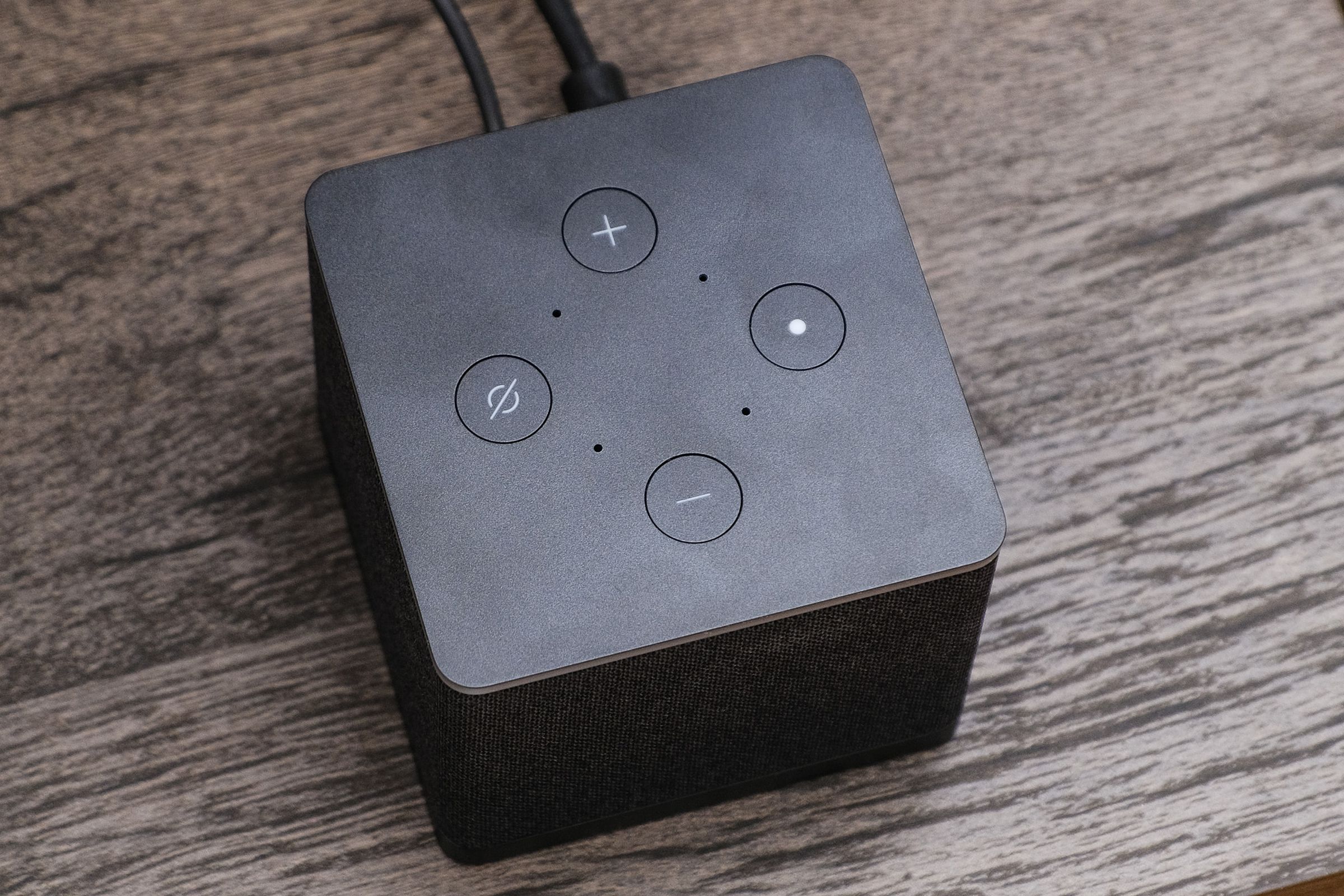 A photo of Amazon’s Fire TV Cube on a TV stand.